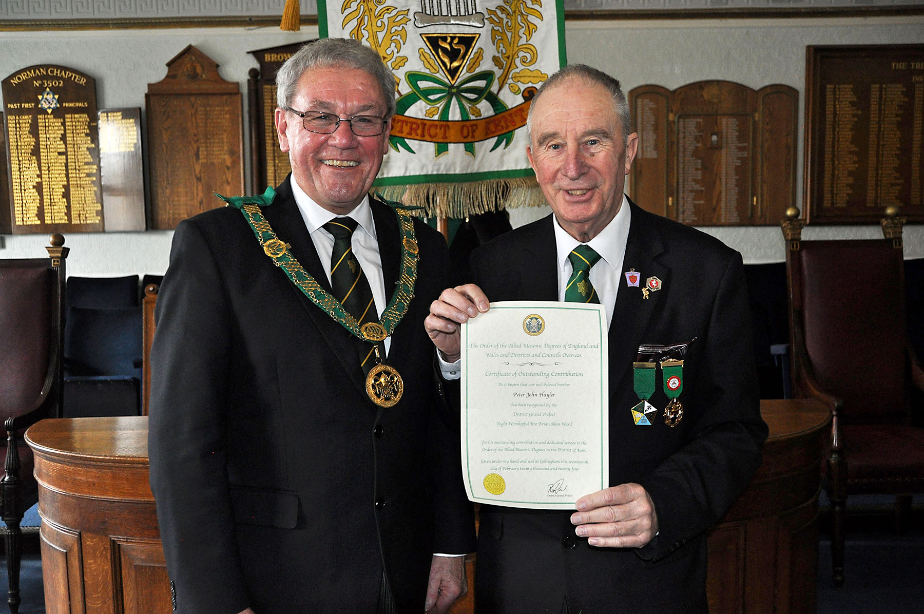 Receiving his certificate for his ‘Outstanding Contribution’ to the District, Peter Hayler in his first year in the Order