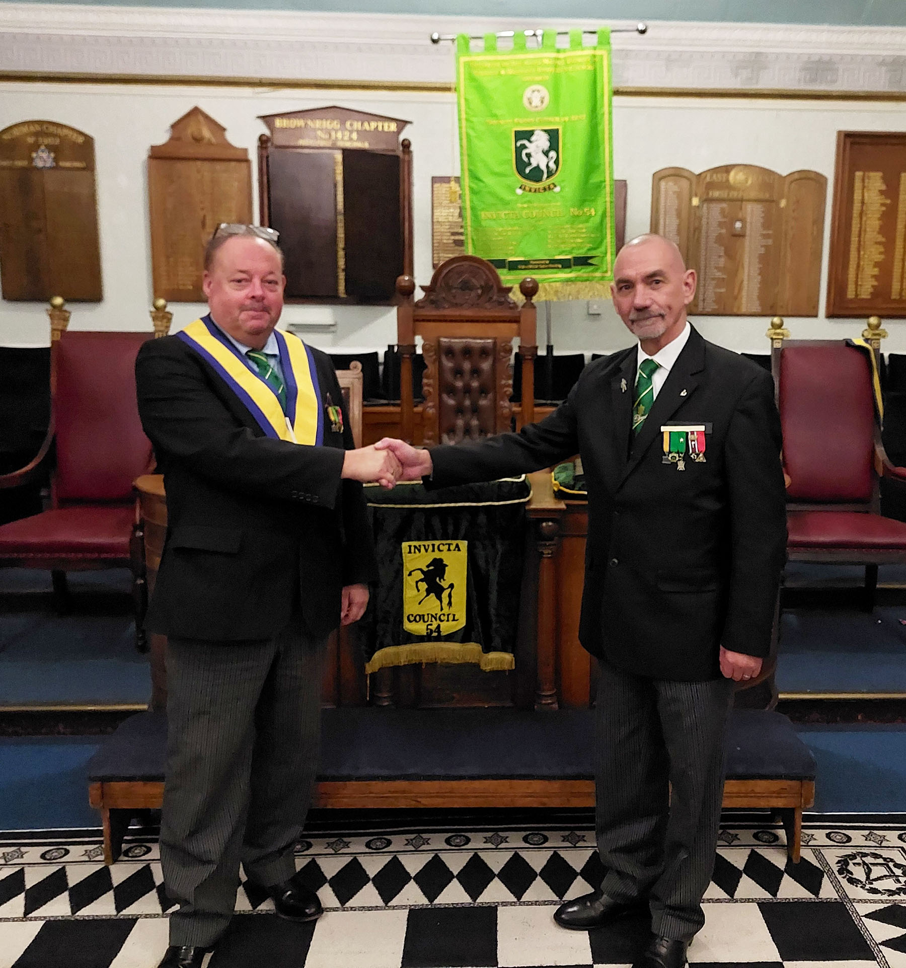 The Worshipful Master W.Bro Bill Pennell being congratulated by Installing Master W. Bro. Neville Fourie